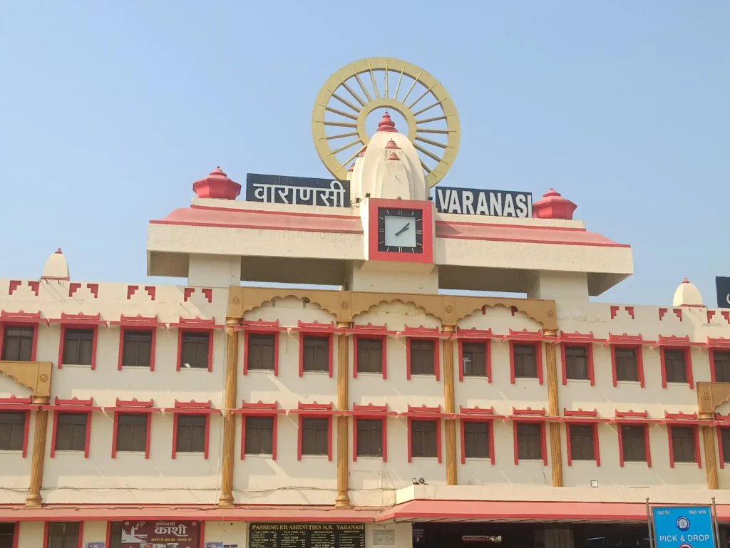 varanasi travel guide building of Varanasi Junction railway station featuring the iconic clock and religious symbols.