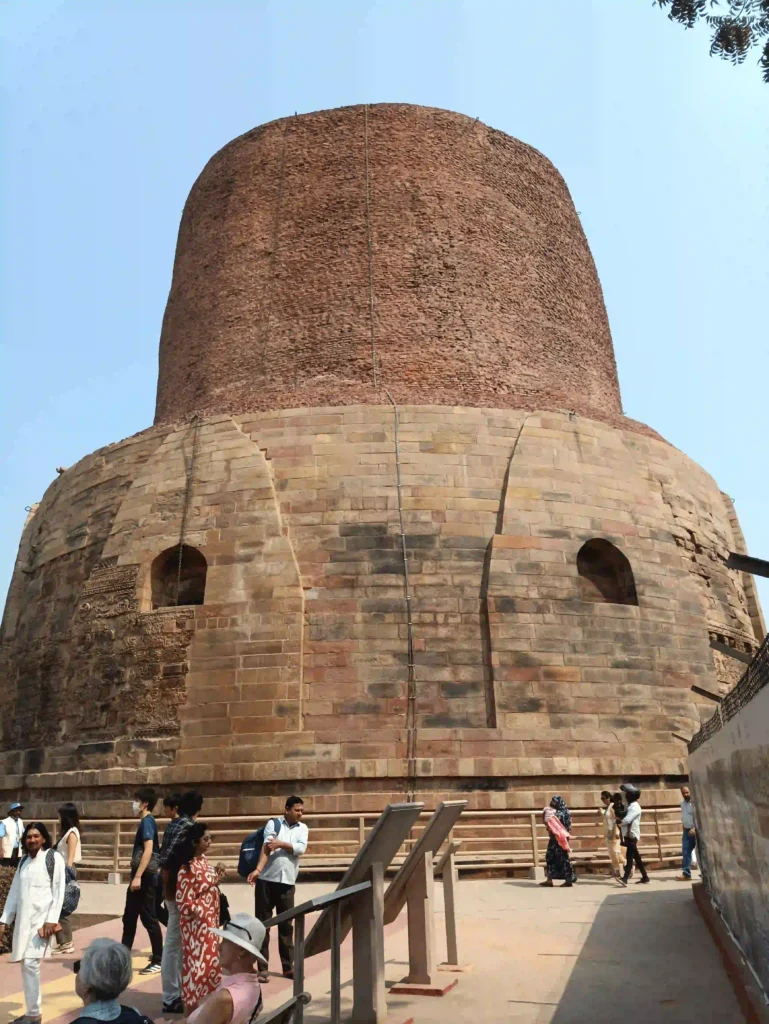 Ancient stupa surrounded by visitors.