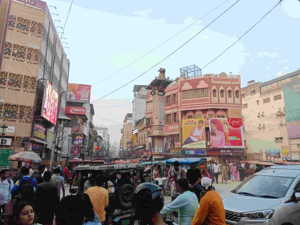 "Varanasi Revolutionary FAQ Part-4: A bustling view of [Godaulia Crossing], the iconic heart of [Kashi], showing traditional architecture and vibrant local life."